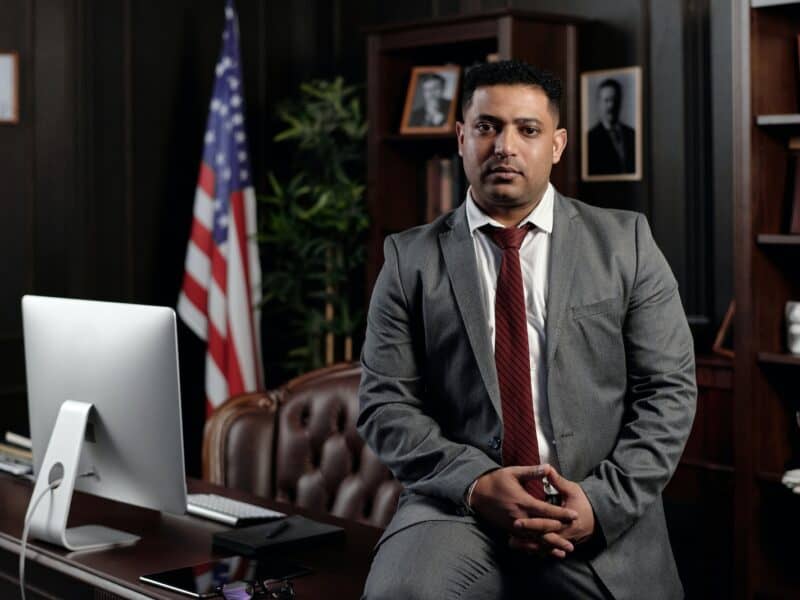 Businessman Sitting on his Desk and Looking at the Camera