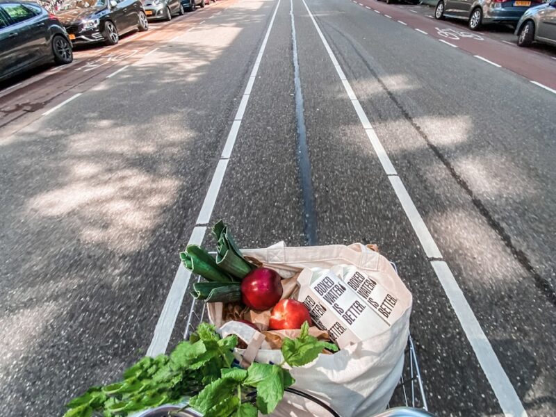 red roses in brown cardboard box on bicycle