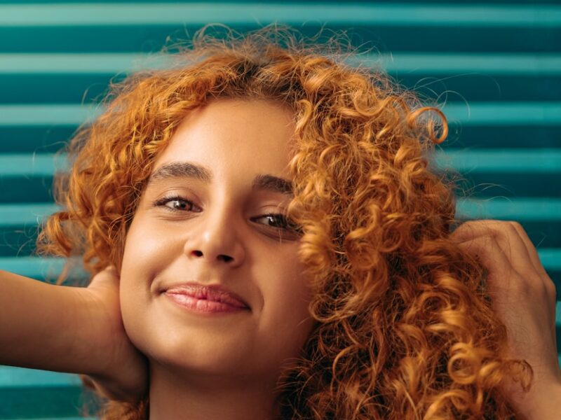 woman in blue sleeveless top smiling