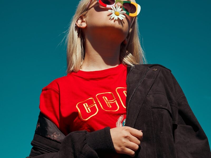 woman with sunglasses standing outdoor during daytime