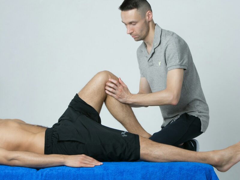 a man getting his leg examined by a doctor