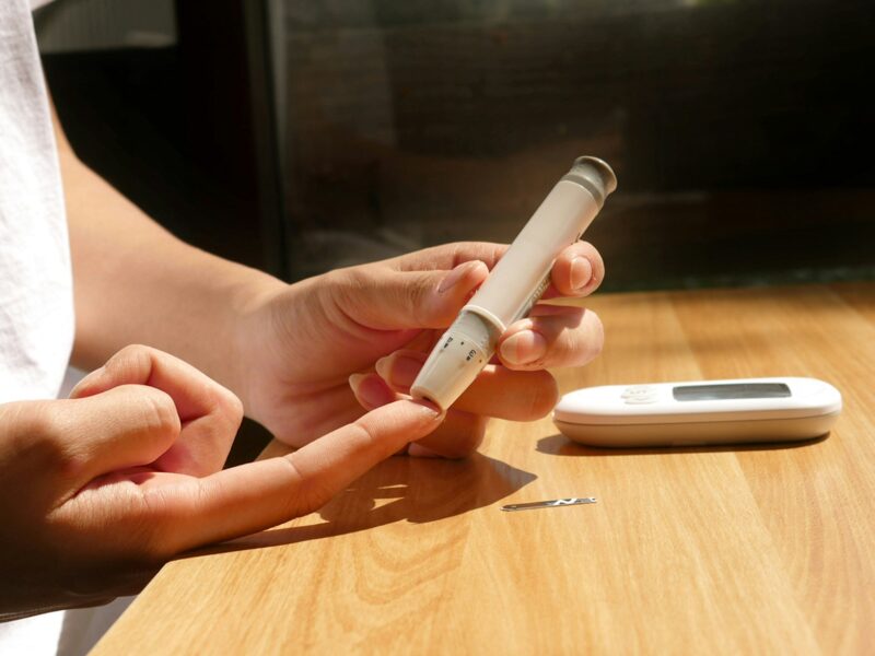 a person sitting at a table with a cell phone