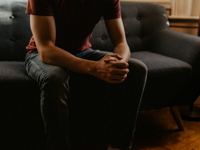 man sitting on sofa