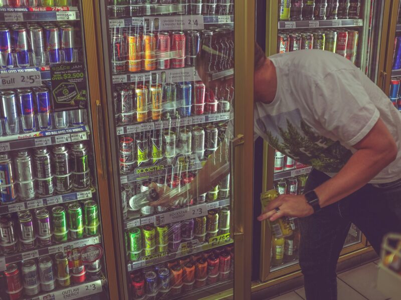 man getting can in beverage cooler