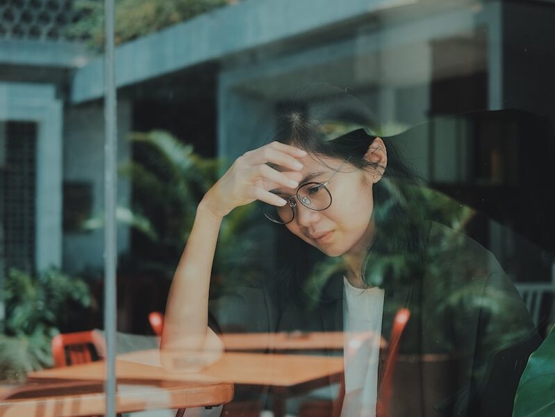 woman touching her forehead