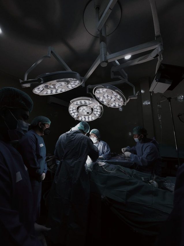 A group of doctors standing around a hospital bed